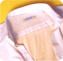 Silicone paper placed over the label on a shirt collar